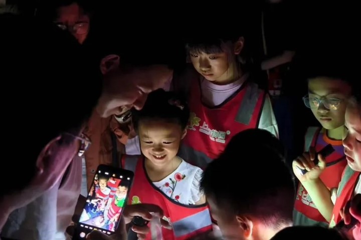 帶教老師通過燈誘吸引昆蟲停留在白色幕布上，用試管採集後給孩子看，夜遊活動後再放歸自然。 圖/取自上海植物園