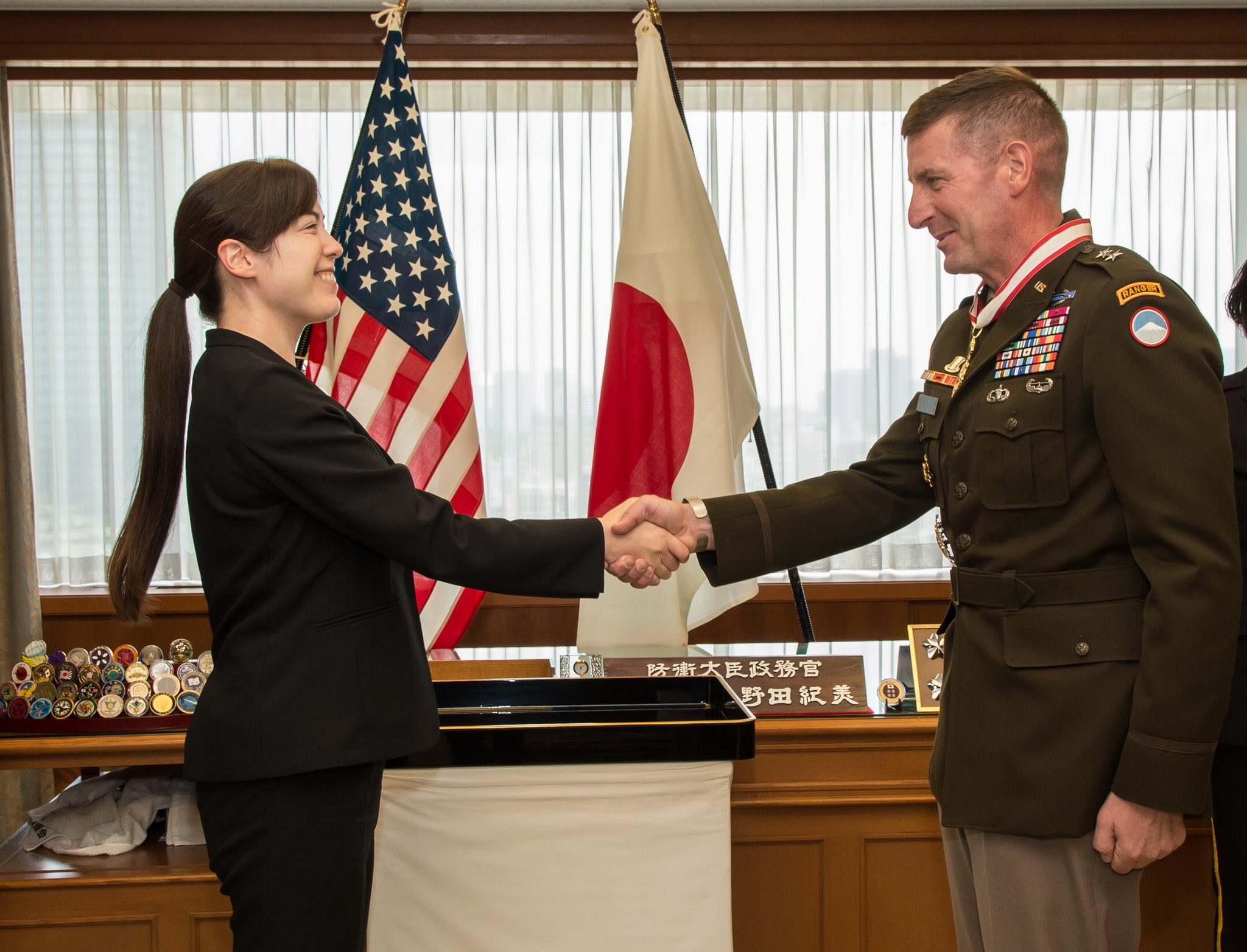 日本防衛大臣政務官小野田紀美（左）向駐日美軍司令沃威爾（Joel B. Vowell，右）少將授勳，表揚他積極致力合作實施日美聯合訓練演習。圖/取自日本防衛省官方《推特》